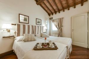 a bedroom with two beds with a tray on it at Buonarroti big apartment with terrace in Oltrarno in Florence