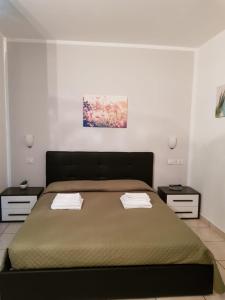 a bedroom with a large bed with two night stands at Hotel Daisy in San Giovanni Lupatoto