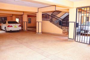 an empty garage with a car parked in it at Lovely One bedroom Apartment , TRM Drive Nairobi in Nairobi