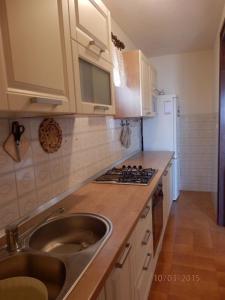 a kitchen with a sink and a stove at Apartments Vesna & Ivica in Mirce