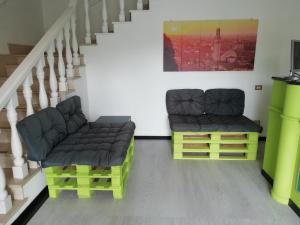 two nesting chairs in a room with stairs at Hotel Daisy in San Giovanni Lupatoto