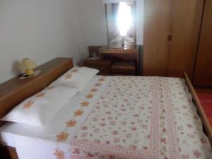 a bedroom with a bed and a table and a mirror at Apartments Vesna & Ivica in Mirce +8 photos