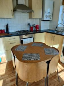a kitchen with a wooden table in a kitchen at Central Taunton 2-bedroom apartment, great location! in Taunton