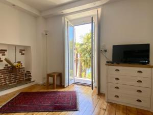 a living room with a dresser and a large sliding glass door at Casa Doris in Oggebbio