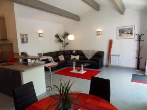 a living room with a couch and a table at Les Hauts d'Eyragues gite Rêverie Meublé classé 4 étoiles in Eyragues