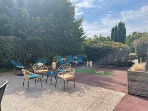 un grupo de sillas y una mesa en un patio en Mercure Rouen Val de Reuil, en Val de Reuil