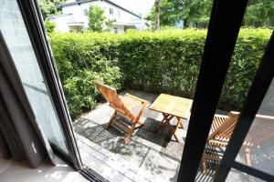 a table and chairs on a patio outside a window at Chuying Sunrise B&B in Jian