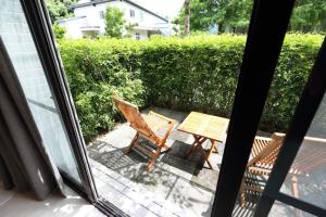 a table and chairs on a patio outside a window at Chuying Sunrise B&B in Ji'an
