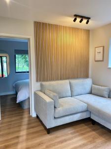 a living room with a couch and a bed at Vallum Cabins in Newcastle upon Tyne