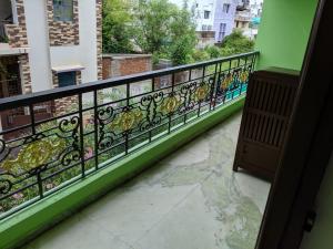 a balcony with a fence with flowers on it at Bluemoon Bungalow in Pondicherry