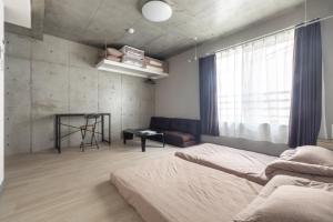 a bedroom with two beds and a couch at Marvelous Koiwa - Vacation STAY 90651v in Tokyo