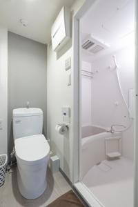 a white bathroom with a toilet and a shower at Marvelous Koiwa - Vacation STAY 90651v in Tokyo