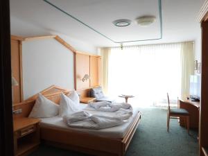 Postel nebo postele na pokoji v ubytování Alpina Mountain Resort + 37 fotografií