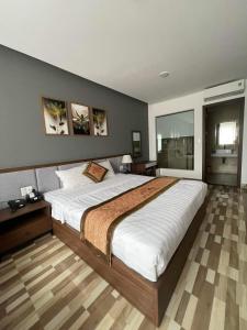 a bedroom with a large bed in a room at Minh Anh Hotel & Apartment in Hai Phong