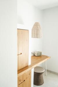 a room with a wooden desk and a lamp at Hotel Boutique & Spa Las Mimosas Ibiza in San Antonio Bay