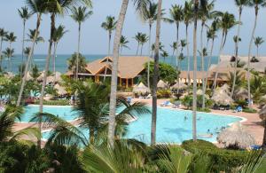 a view of a resort pool with palm trees at VIK hotel Arena Blanca in Punta Cana