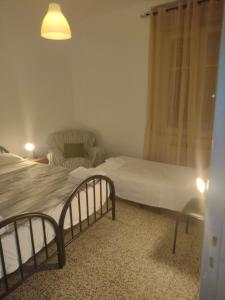 a bedroom with a bed and a chair and a couch at CINQUE TERRE HOUSE OF THE PORT with PARKING in La Spezia
