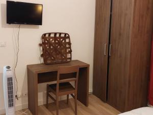 a room with a desk with a chair and a television at Happy Land Holliday residential in Épinay-sur-Seine