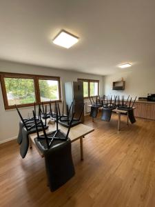 a room with a row of tables and chairs at Apartmotel ANROE in Chminianska Nová Ves