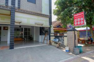 a building with a sign on the side of it at RedDoorz Syariah near Alun Alun Kajen in Pekalongan