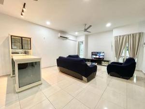 a living room with two couches and a tv at Langkawi Cozy Holiday Home at Taman Simfoni by Zervin in Kuah