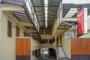 an empty hallway of a school building with stairs at RedDoorz Syariah near GOR Satria 4 in Sumbang
