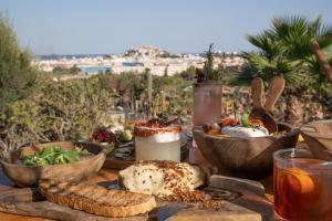 a table with bowls of food on a table with a view at Casa Maca in Ibiza Town