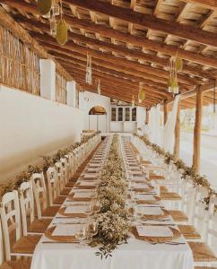 a long banquet hall with white tables and flowers at Casa Lucia in Sorrento