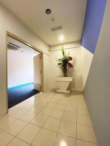 a hallway with a potted plant in a room at Your Hotel Klang by D'concept in Klang