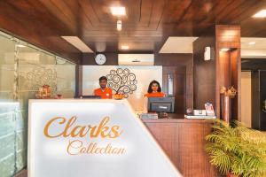 two people sitting at a counter in a restaurant at Hotel Clarks Collection Vadodara in Vadodara