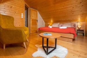 a bedroom with a bed and a table and a chair at Chalet Ajda in Bohinj