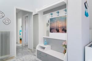 a white bathroom with a sink and a mirror at yiayia and papou Luxury House in Limenas +46 photos