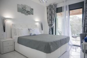 A bed or beds in a room at Diamond Luxury Villa Corfu