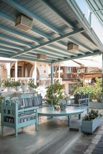 a patio with two benches and a table at Samaria Studios in Hora Sfakion