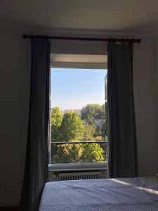 a bedroom with a window with a view at La dulce stanza in Genova