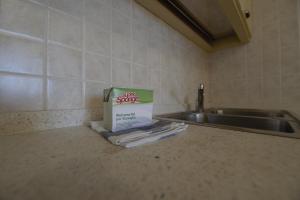 a box sitting on a counter next to a sink at Le Residenze di Santa Costanza - Mirto/Corbezzolo in San Vincenzo +24 photos