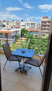 a blue table and two chairs on a balcony at Telethrio in Loutra Edipsou