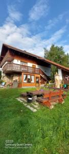 a building with a picnic table in front of it at Ubytování v šumavském domě in Nové Hutě