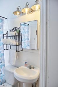 a bathroom with a sink and a mirror and a toilet at Little Havana Executive 11 in Miami