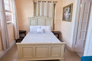 a bedroom with a bed with a white headboard at Little Havana Executive 11 in Miami