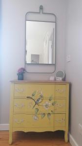 a yellow dresser with a mirror on top of it at No 12 B&B in Dungarvan