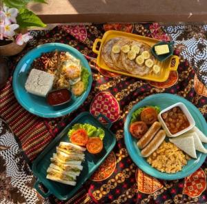 a table with three plates of food on it at Api-api Eco Chalet in Pantai Kok