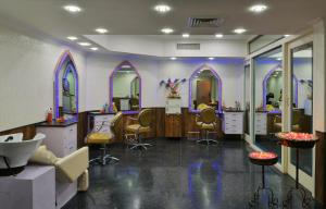 a salon with chairs and mirrors in a room at Noor-Us-Sabah Palace in Bhopal