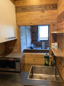 a kitchen with a stainless steel sink and a window at Incantevole appartamento stile chalet Breuil Cervinia in Breuil-Cervinia