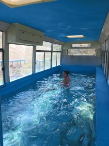 a little girl in a swimming pool in a boat at Guest House AREVIK in Artsvakar