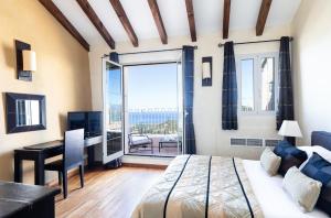 Schlafzimmer mit einem Bett, einem Schreibtisch und einem Fenster in der Unterkunft CASA SANTA MARIA in Santa-Reparata-di-Balagna