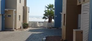 an empty alley with the ocean in the background at Waterfront G8 Swakopmund in Mondesa