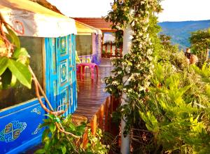 a house with a wooden walkway leading to a porch at Exclusive Nirvana yurts Glamping in Kato Drys