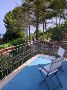une chaise assise sur une terrasse à côté d'une clôture dans l'établissement Villa Bouganvilla, à Cefalù