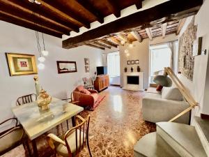 a living room with a table and chairs at [Art of Bergamo] Luxury & design house in Bergamo